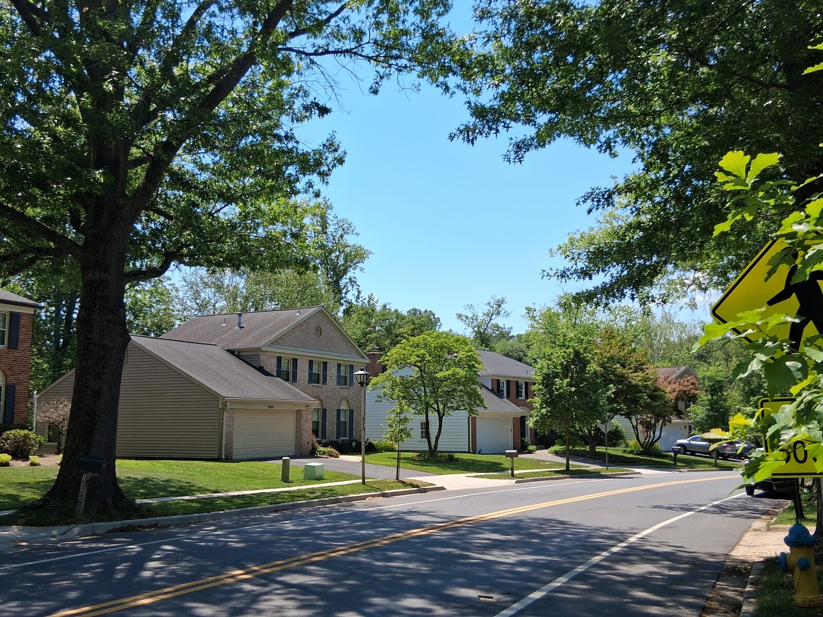 Wide, curving street with spacious lawns in Fallsmead, Rockville
