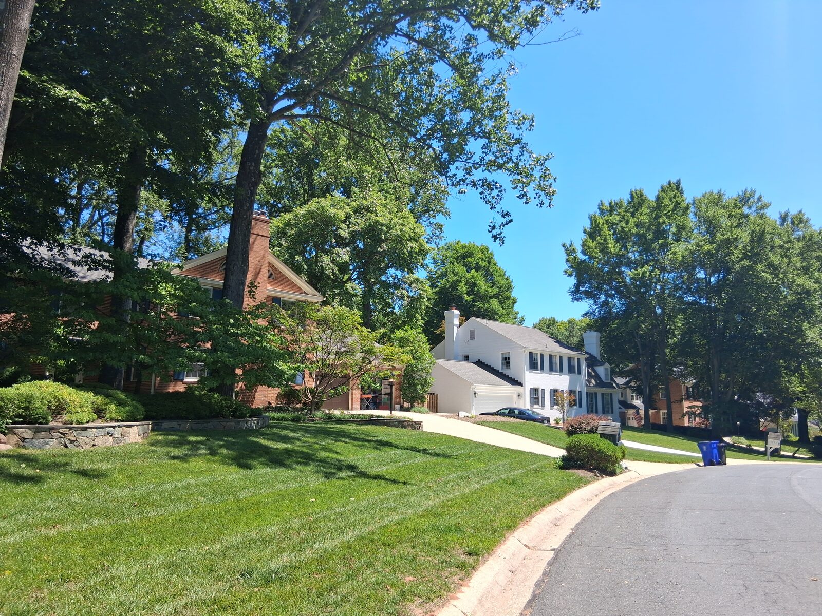 Colonial-style residences along a quiet street in River Falls, Potomac