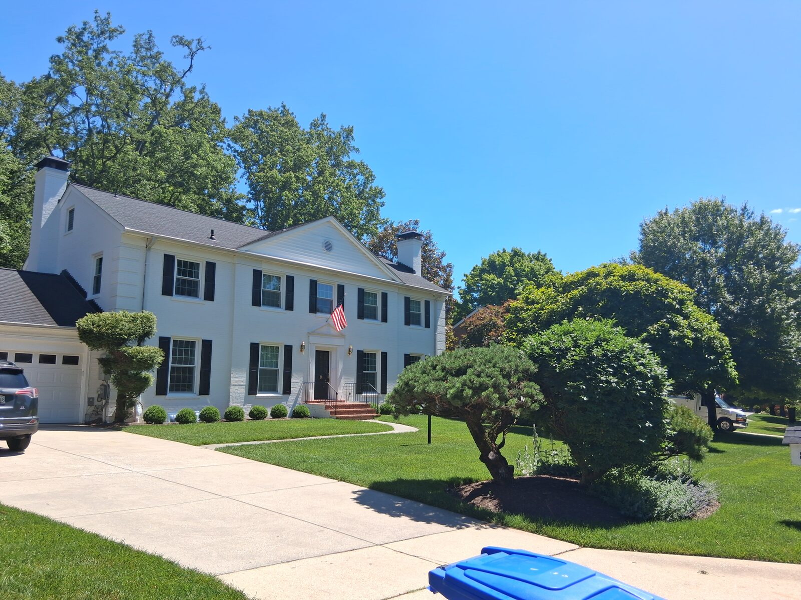 White colonial home with a long driveway in River Falls, Potomac